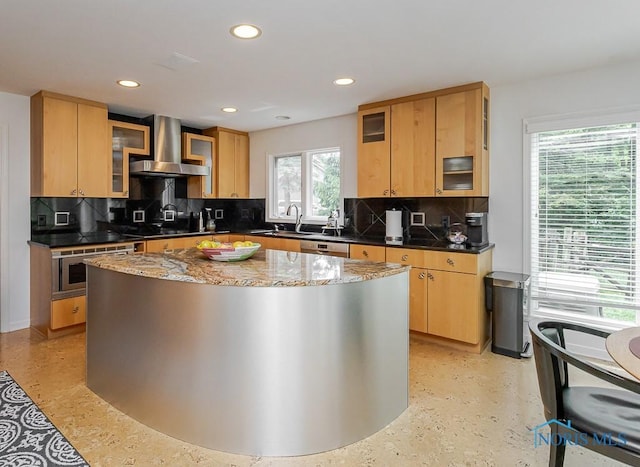 7559 Peachtree Ln, Sylvania, OH 43560 - kitchen featuring wall chimney exhaust hood, recessed lighting, dark stone counters, tasteful backsplash, and glass insert cabinets