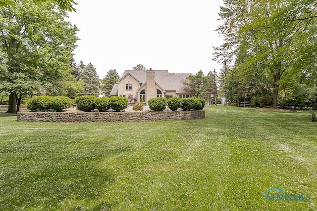 7559 Peachtree Ln, Sylvania, OH 43560 - view of front of home with a chimney and a front yard