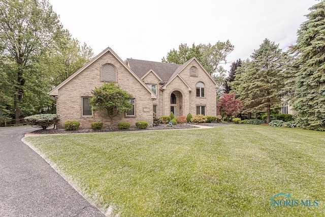 7559 Peachtree Ln, Sylvania, OH 43560 - french country style house with brick siding and a front yard