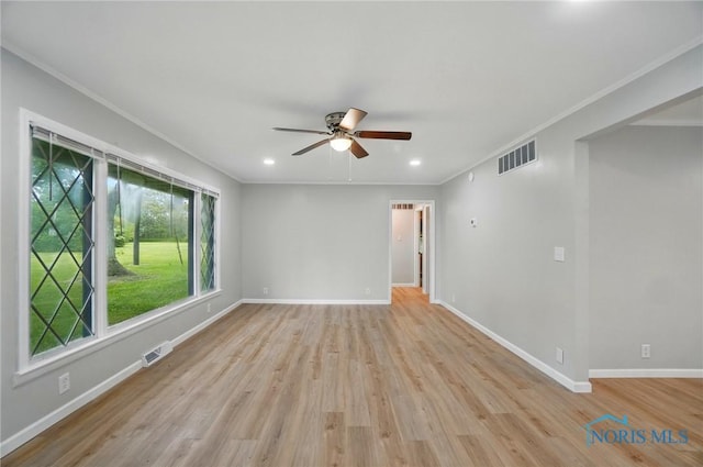 130 Vine St, Risingsun, OH 43457 - empty room featuring a ceiling fan, crown molding, baseboards, light wood-type flooring, and recessed lighting