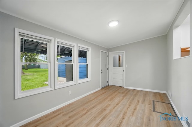 130 Vine St, Risingsun, OH 43457 - spare room with light wood-style flooring, baseboards, and crown molding