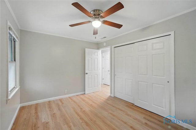 130 Vine St, Risingsun, OH 43457 - unfurnished bedroom featuring light wood-style floors, crown molding, baseboards, a closet, and ceiling fan