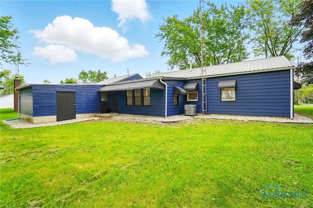 130 Vine St, Risingsun, OH 43457 - back of property with a yard and central air condition unit