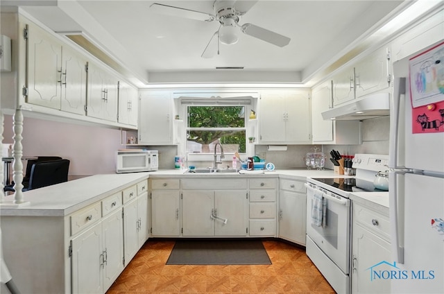 18827 State Route 2, Wauseon, OH 43567 - kitchen with white appliances, a sink, under cabinet range hood, a ceiling fan, and a peninsula