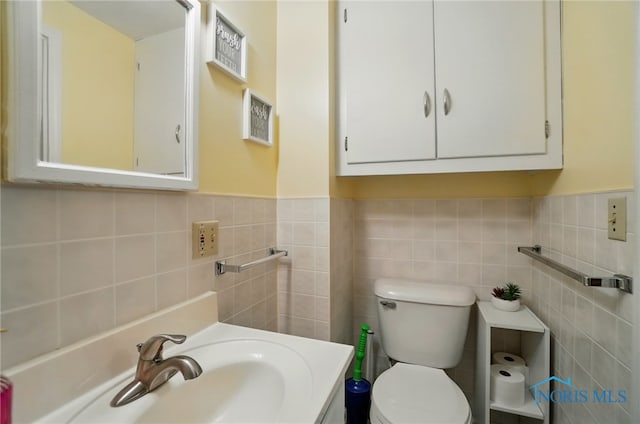 18827 State Route 2, Wauseon, OH 43567 - bathroom featuring toilet, vanity, wainscoting, and tile walls