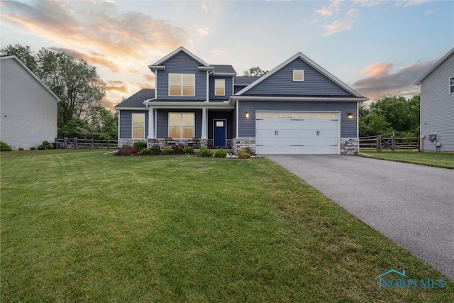840 Wilkshire Dr, Waterville, OH 43566 - view of front of house with asphalt driveway, stone siding, and a garage