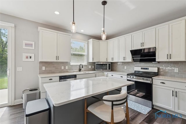 840 Wilkshire Dr, Waterville, OH 43566 - kitchen with appliances with stainless steel finishes, range hood, a breakfast bar, healthy amount of natural light, and recessed lighting