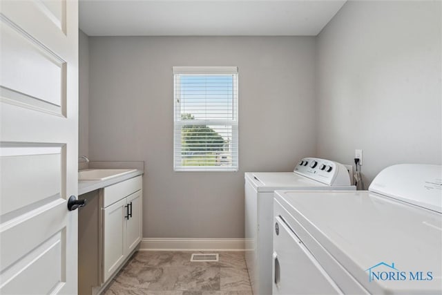 840 Wilkshire Dr, Waterville, OH 43566 - laundry area featuring washing machine and dryer, cabinet space, and baseboards