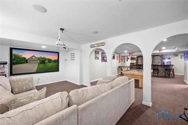 12158 Jefferson St, Perrysburg, OH 43551 - cinema room featuring dark colored carpet, arched walkways, baseboards, recessed lighting, and bar area