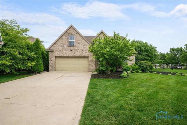 12158 Jefferson St, Perrysburg, OH 43551 - view of front of property featuring concrete driveway, brick siding, and a garage