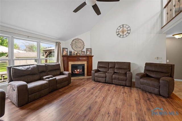 12158 Jefferson St, Perrysburg, OH 43551 - living room with high vaulted ceiling, ceiling fan, wood-type flooring, and a tile fireplace
