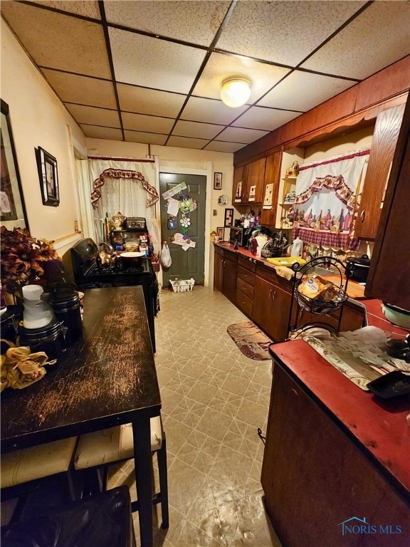 629 Hamilton St, Toledo, OH 43604 - kitchen featuring tile patterned floors and a paneled ceiling