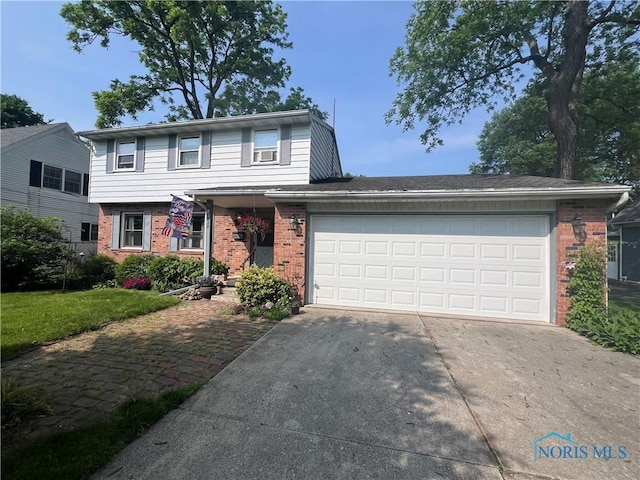 828 Louisiana Ave, Perrysburg, OH 43551 - view of front of house featuring brick siding, concrete driveway, and an attached garage