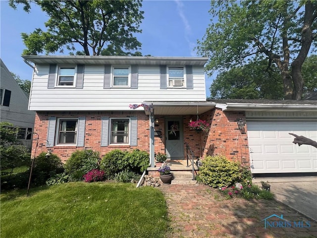 828 Louisiana Ave, Perrysburg, OH 43551 - view of front of home featuring brick siding, a garage, and a front lawn