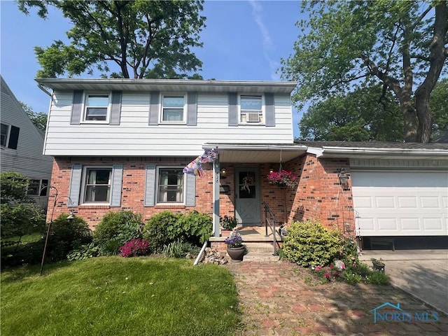 828 Louisiana Ave, Perrysburg, OH 43551 - view of front of home featuring brick siding, an attached garage, and a front yard