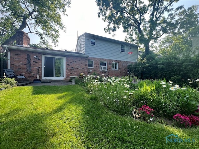 828 Louisiana Ave, Perrysburg, OH 43551 - rear view of house with brick siding and a chimney