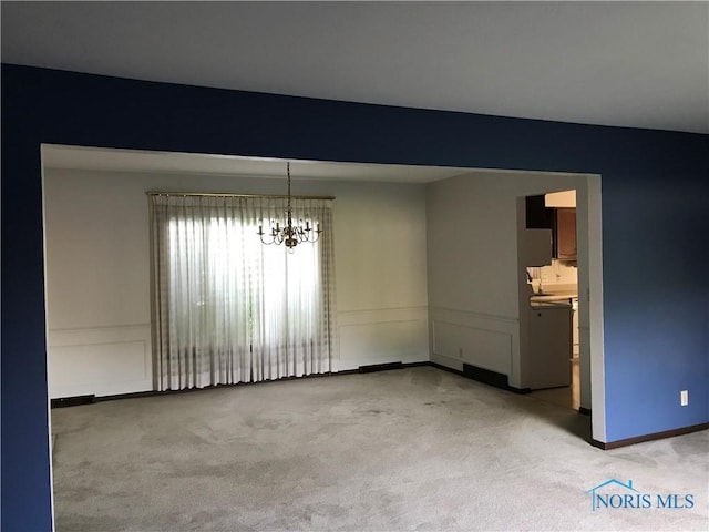 2024 Inglewood Rd, Holland, OH 43528 - empty room featuring light carpet and a chandelier