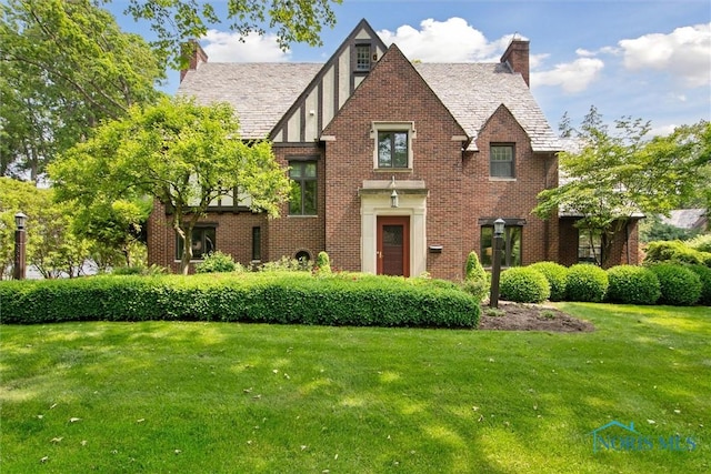 3534 Edgevale Rd, Ottawa Hills, OH 43606 - view of front of property featuring a front lawn, brick siding, a chimney, and a high end roof
