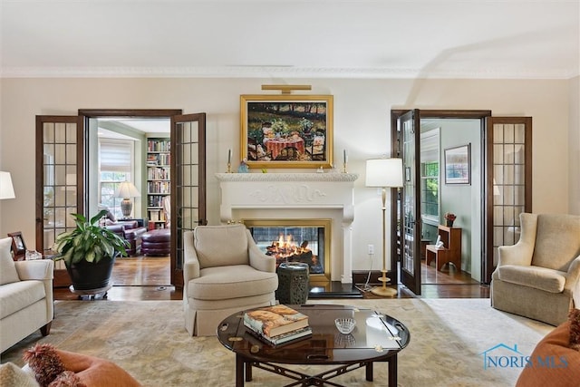 3534 Edgevale Rd, Ottawa Hills, OH 43606 - living room with wood finished floors, crown molding, a glass covered fireplace, and healthy amount of natural light