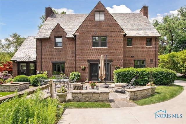 3534 Edgevale Rd, Ottawa Hills, OH 43606 - back of house featuring a high end roof, a chimney, a patio area, and brick siding