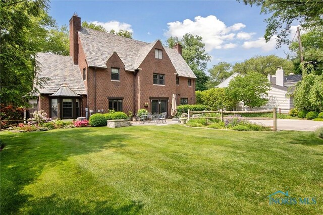 3534 Edgevale Rd, Ottawa Hills, OH 43606 - back of property featuring brick siding, a chimney, a high end roof, and a patio area