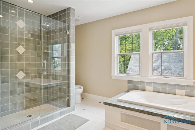3534 Edgevale Rd, Ottawa Hills, OH 43606 - full bathroom featuring a shower stall, a bath, tile patterned flooring, toilet, and baseboards