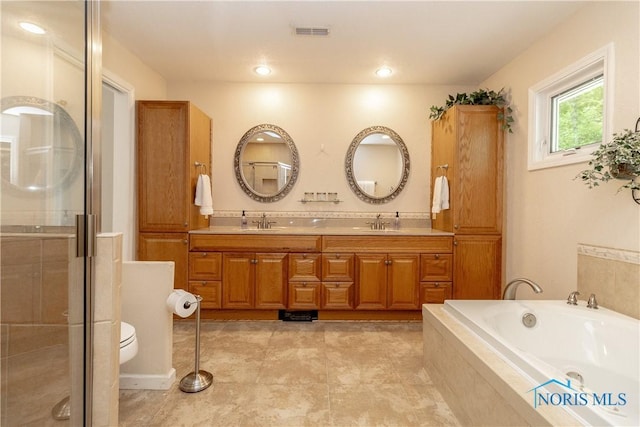 7915 W Bancroft St, Toledo, OH 43617 - full bathroom featuring double vanity, a shower stall, a garden tub, and toilet
