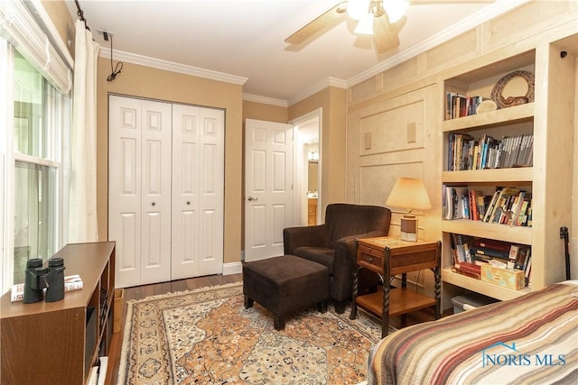 7915 W Bancroft St, Toledo, OH 43617 - bedroom featuring wood finished floors, crown molding, a closet, a ceiling fan, and baseboards