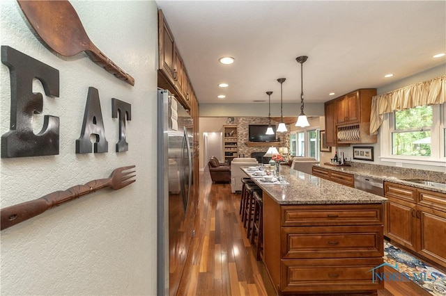 7915 W Bancroft St, Toledo, OH 43617 - kitchen with appliances with stainless steel finishes, open floor plan, a center island, recessed lighting, and stone countertops