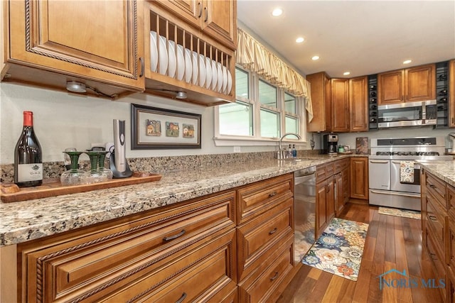 7915 W Bancroft St, Toledo, OH 43617 - kitchen with appliances with stainless steel finishes, a sink, brown cabinetry, dark wood-style flooring, and recessed lighting