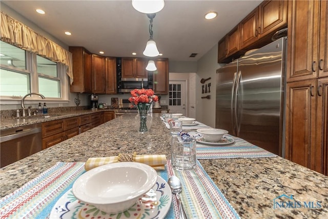 7915 W Bancroft St, Toledo, OH 43617 - kitchen featuring stainless steel appliances, a sink, light stone counters, recessed lighting, and hanging light fixtures