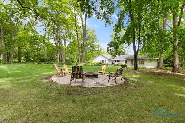 7915 W Bancroft St, Toledo, OH 43617 - view of grassy yard with a fire pit