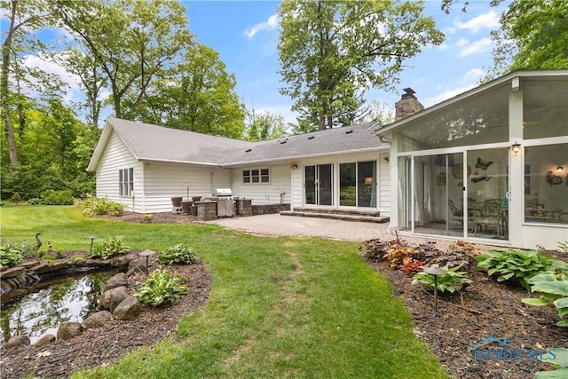 7915 W Bancroft St, Toledo, OH 43617 - rear view of property featuring a chimney, a patio area, and a yard