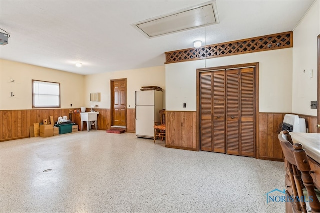 1008 Muirfield Dr, Findlay, OH 45840 - garage with freestanding refrigerator, wainscoting, wood walls, and a sink