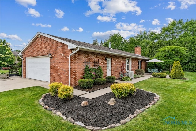 1008 Muirfield Dr, Findlay, OH 45840 - view of front of house with brick siding, an attached garage, a chimney, a front yard, and driveway