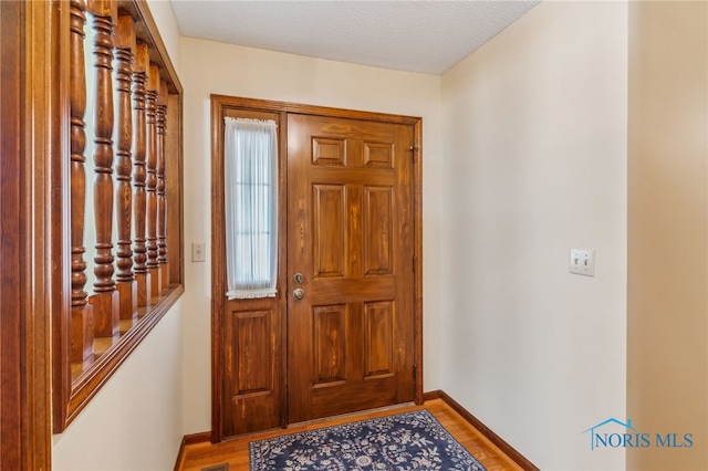 1008 Muirfield Dr, Findlay, OH 45840 - entryway with baseboards and wood finished floors