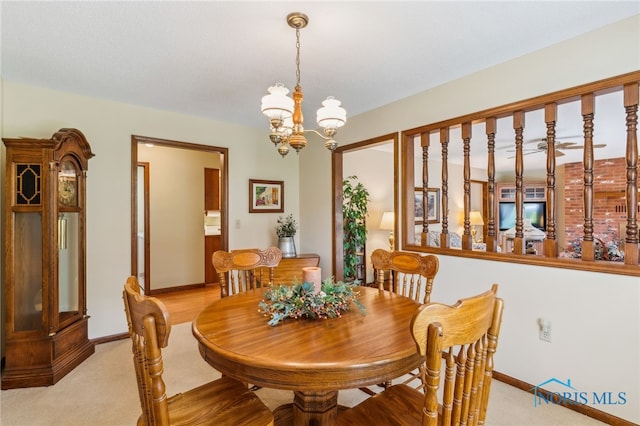 1008 Muirfield Dr, Findlay, OH 45840 - dining area with baseboards, light colored carpet, and a chandelier