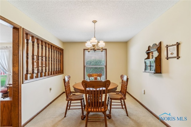 1008 Muirfield Dr, Findlay, OH 45840 - dining room featuring a chandelier, plenty of natural light, light colored carpet, and a textured ceiling