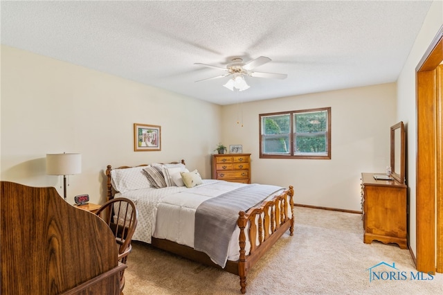 1008 Muirfield Dr, Findlay, OH 45840 - bedroom with light carpet, ceiling fan, baseboards, and a textured ceiling