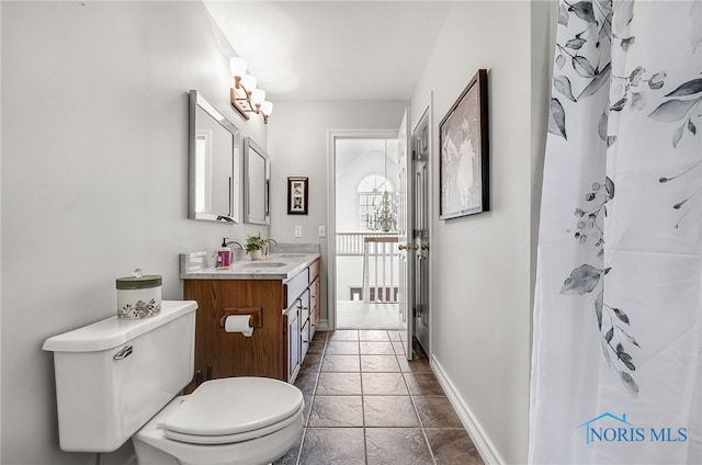 8832 Orchard Lake Rd, Holland, OH 43528 - bathroom with toilet, vanity, baseboards, stone tile flooring, and a shower with curtain