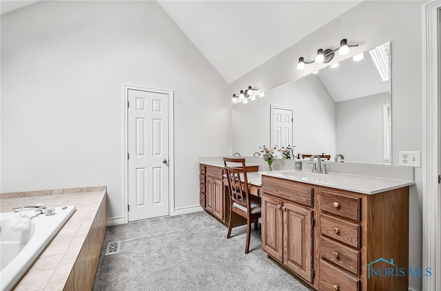 8832 Orchard Lake Rd, Holland, OH 43528 - full bathroom with vanity, a skylight, a garden tub, high vaulted ceiling, and baseboards