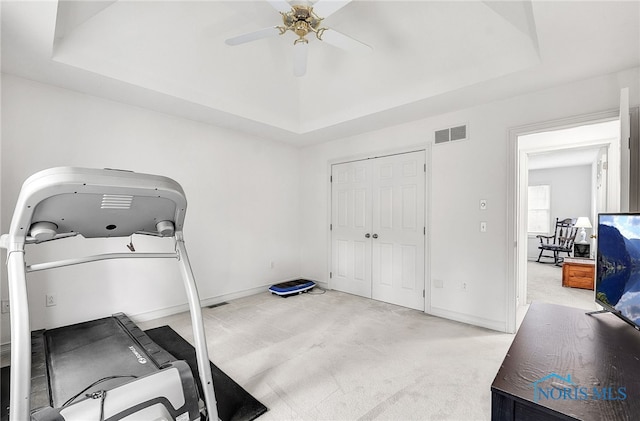 8832 Orchard Lake Rd, Holland, OH 43528 - workout area with a tray ceiling, light colored carpet, and a ceiling fan