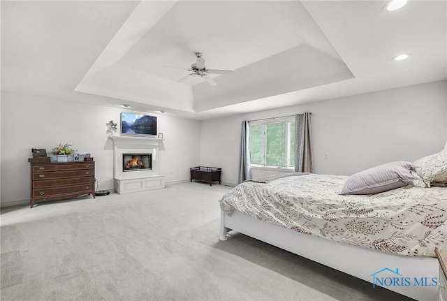 8832 Orchard Lake Rd, Holland, OH 43528 - bedroom featuring a raised ceiling, carpet floors, a glass covered fireplace, recessed lighting, and a ceiling fan