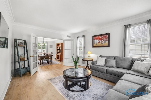 8832 Orchard Lake Rd, Holland, OH 43528 - living area with light wood-type flooring, ornamental molding, french doors, baseboards, and a chandelier