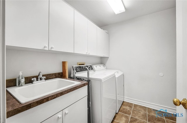 8832 Orchard Lake Rd, Holland, OH 43528 - laundry room with cabinet space, washing machine and clothes dryer, dark tile patterned flooring, and baseboards