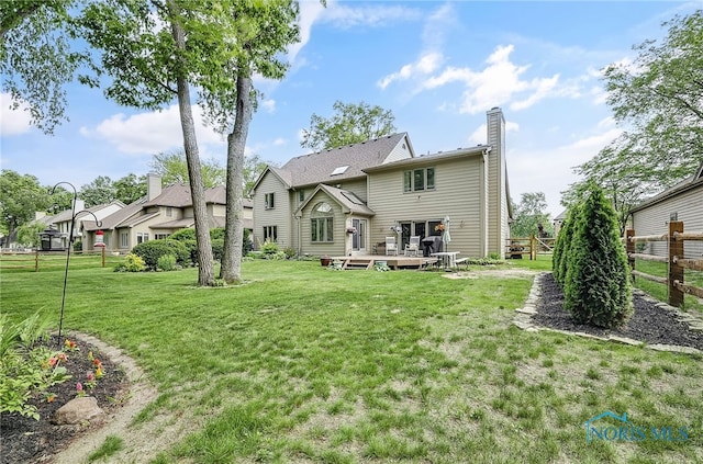 8832 Orchard Lake Rd, Holland, OH 43528 - rear view of house with a wooden deck and a chimney