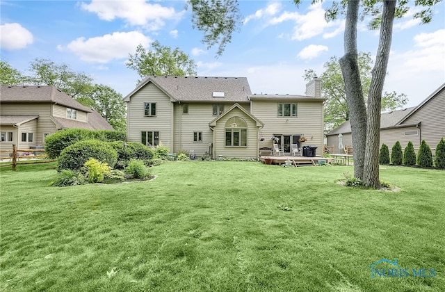 8832 Orchard Lake Rd, Holland, OH 43528 - rear view of property with a deck, a lawn, and a chimney