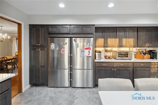 25581 Normandy Rd, Perrysburg, OH 43551 - kitchen with light countertops, a chandelier, freestanding refrigerator, and recessed lighting