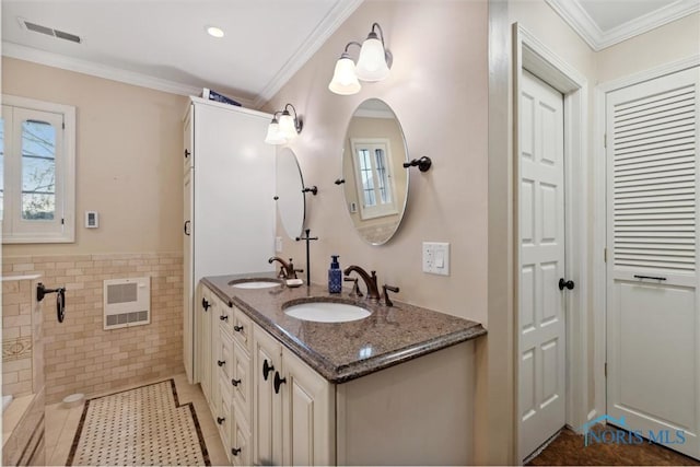 25581 Normandy Rd, Perrysburg, OH 43551 - bathroom with heating unit, a closet, double vanity, tile walls, and wainscoting