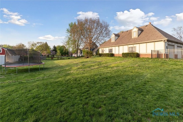 25581 Normandy Rd, Perrysburg, OH 43551 - view of yard featuring a trampoline and an attached garage